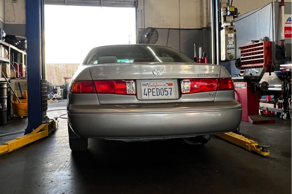 Car Repair and Maintenance in Fremont, CA with Driven Auto Care. Image of a gray Toyota Camry V6 undergoing regular maintenance at Driven Auto Care